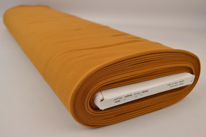 Mörk ockragul french terry – mjuk bomullsstickad metervara med stretch (bild 2 av 5)